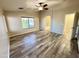 Spacious main bedroom featuring laminate flooring, window with blinds, and an ensuite bathroom at 10031 W Hess St, Tolleson, AZ 85353