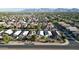 Wide aerial shot showcasing the expansive neighborhood, complete with homes, streets, and mountain views in the distance at 10031 W Hess St, Tolleson, AZ 85353