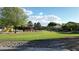 A well-maintained neighborhood park featuring mature trees, a gazebo, playground equipment, and expansive green space at 10031 W Hess St, Tolleson, AZ 85353