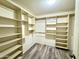 Spacious walk-in closet with built-in shelves and hanging rods for optimal storage solutions at 10031 W Hess St, Tolleson, AZ 85353