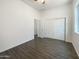 Neutral bedroom with wood-look tile floors, closet, and window providing natural light at 10531 E Nopal Ave, Mesa, AZ 85209