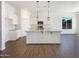 Open kitchen with granite countertops, a center island, stainless appliances, and white cabinets at 10531 E Nopal Ave, Mesa, AZ 85209