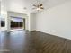 Bright living room featuring wood-look tile floors, a ceiling fan, and sliding glass doors to the exterior at 10531 E Nopal Ave, Mesa, AZ 85209