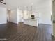 Open-concept living space showcasing tile floors, recessed lighting, and a kitchen with island and white cabinets at 10531 E Nopal Ave, Mesa, AZ 85209