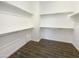 Walk-in closet offering built-in shelving and wood-look tile flooring at 10531 E Nopal Ave, Mesa, AZ 85209