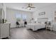 Bright bedroom with a ceiling fan, two windows with views, and light-colored walls at 11008 N 165Th Ave, Surprise, AZ 85388