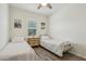 Well-lit bedroom showcasing twin beds with neutral bedding and a window for natural light at 11008 N 165Th Ave, Surprise, AZ 85388