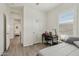 Cozy bedroom area with a desk and chair, perfect for study or work, next to an open door at 11008 N 165Th Ave, Surprise, AZ 85388