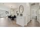 Inviting hallway with neutral tones, featuring dining area view and a decorative cabinet at 11008 N 165Th Ave, Surprise, AZ 85388