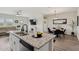 Inviting kitchen area featuring modern appliances, an island with seating, and an open view to the living area at 11008 N 165Th Ave, Surprise, AZ 85388