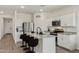 Well-lit kitchen featuring granite countertops, stainless steel appliances, and a breakfast bar at 11008 N 165Th Ave, Surprise, AZ 85388