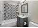 Well-lit bathroom featuring a patterned shower and a gray vanity with silver hardware at 1106 W Glenrosa Ave, Phoenix, AZ 85013