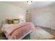 Cozy bedroom with neutral walls, plush area rug, and large closet doors at 1106 W Glenrosa Ave, Phoenix, AZ 85013