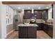 Modern kitchen featuring stainless steel appliances, dark cabinetry, and a granite countertop island at 1106 W Glenrosa Ave, Phoenix, AZ 85013