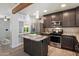 Modern kitchen with stainless appliances, a granite island, and dark cabinetry at 1106 W Glenrosa Ave, Phoenix, AZ 85013