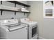 Laundry room with open shelving and modern washer and dryer at 1106 W Glenrosa Ave, Phoenix, AZ 85013