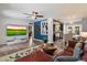 Open-concept living space featuring hardwood floors, modern lighting, and a mounted television at 1106 W Glenrosa Ave, Phoenix, AZ 85013