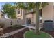 Enchanting back yard with a cozy patio, a seating area, desert themed wall art, and drought-tolerant landscape design at 1114 W Windjammer Dr, Gilbert, AZ 85233