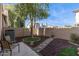 Serene back yard with a stone pathway, a charming seating area, and attractive landscaping for tranquil outdoor enjoyment at 1114 W Windjammer Dr, Gilbert, AZ 85233
