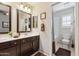 Well-lit bathroom features a double sink vanity, framed mirror, and a separate toilet and shower area at 1114 W Windjammer Dr, Gilbert, AZ 85233