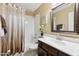 Bright bathroom featuring a shower-tub combo, a stylish mirror, and a vanity with modern fixtures at 1114 W Windjammer Dr, Gilbert, AZ 85233