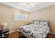 Comfortable bedroom featuring a shuttered window, hardwood floors, and soft lighting, creating a peaceful retreat at 1114 W Windjammer Dr, Gilbert, AZ 85233