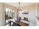Charming dining room with sliding glass doors to the patio, modern chandelier and plenty of natural light at 1114 W Windjammer Dr, Gilbert, AZ 85233