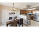 Inviting dining area adjacent to a kitchen with dark cabinets and stainless steel appliances at 1114 W Windjammer Dr, Gilbert, AZ 85233