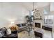 Bright living room featuring a fireplace, ceiling fan, and a comfortable seating area perfect for relaxation and entertaining at 1114 W Windjammer Dr, Gilbert, AZ 85233
