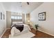 Comfortable main bedroom with natural lighting, complemented by a plush bed, wood floors, and plants for a relaxing ambiance at 1114 W Windjammer Dr, Gilbert, AZ 85233