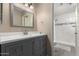 Modern bathroom features a gray vanity, a framed mirror, and a stunning walk-in shower at 1217 N Miller Rd # 32, Scottsdale, AZ 85257