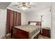 Bedroom with ceiling fan, dark wood furniture, and wood-look laminate flooring at 1217 N Miller Rd # 32, Scottsdale, AZ 85257
