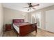 Bedroom with wood-look flooring, ceiling fan, and access to the outdoor patio at 1217 N Miller Rd # 32, Scottsdale, AZ 85257