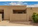 Exterior view of the home showcasing the stucco facade and well-maintained landscaping at 1217 N Miller Rd # 32, Scottsdale, AZ 85257