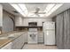 Functional kitchen with white cabinets and appliances, ready for cooking and meal preparation at 1217 N Miller Rd # 32, Scottsdale, AZ 85257