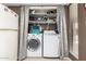 Functional laundry room with full-size washer and dryer and ample storage shelving at 1217 N Miller Rd # 32, Scottsdale, AZ 85257