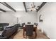 The living room opens to dining area with beams and neutral colors, ideal for Gathering meals and gatherings at 1217 N Miller Rd # 32, Scottsdale, AZ 85257