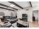 Comfortable living room with beamed ceilings and open layout to dining area and kitchen at 1217 N Miller Rd # 32, Scottsdale, AZ 85257