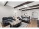 The living room is furnished with leather couches, a glass table, and a decorative rug at 1217 N Miller Rd # 32, Scottsdale, AZ 85257