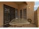 Inviting patio space with security doors and a glass-topped table, ideal for relaxation at 1217 N Miller Rd # 32, Scottsdale, AZ 85257
