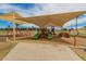 Community playground with swings, slides, and climbing structures shaded by canopies at 1217 N Miller Rd # 32, Scottsdale, AZ 85257