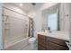 Clean bathroom with white cabinets, a framed mirror, and a shower-tub combo at 12316 W Wagon Wheel Dr, Glendale, AZ 85307