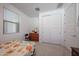 Cozy bedroom with a large window, closet, and carpeted floor at 12316 W Wagon Wheel Dr, Glendale, AZ 85307