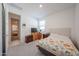 Comfortable bedroom featuring a bed, dresser, and view into another room at 12316 W Wagon Wheel Dr, Glendale, AZ 85307