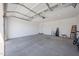 Spacious three-car garage featuring an automatic door and plenty of storage at 12316 W Wagon Wheel Dr, Glendale, AZ 85307
