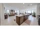 Modern kitchen island with quartz countertops, leading to the dining and living areas at 12316 W Wagon Wheel Dr, Glendale, AZ 85307