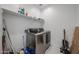 Bright laundry room with stainless steel washer and dryer and ample storage space at 12316 W Wagon Wheel Dr, Glendale, AZ 85307