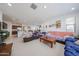 Bright living room featuring tile flooring, a ceiling fan, and an open floor plan at 12316 W Wagon Wheel Dr, Glendale, AZ 85307