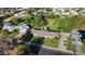 A lush, green residential neighborhood featuring a home with a pool and spacious lawn with mature trees at 125 N Fraser E Dr, Mesa, AZ 85203