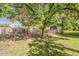 Backyard featuring lush lawn and a fenced off area with large mature trees at 125 N Fraser E Dr, Mesa, AZ 85203